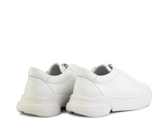 White leather sneakers with zipper in front instead of laces. Casual women's style. White rubber...