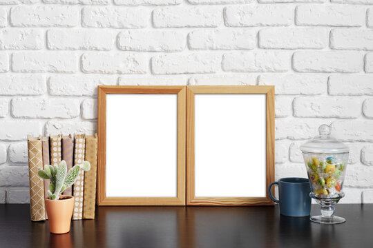 Books with picture frame on wooden table