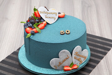 Birthday cake for a man's birthday. The inscription on the cake: "To the best father, beloved husband. Happy Anniversary!" Beautiful 50th birthday cake.