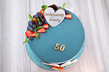 Birthday cake for a man's birthday. The inscription on the cake: "To the best father, beloved husband. Happy Anniversary!" Beautiful 50th birthday cake.