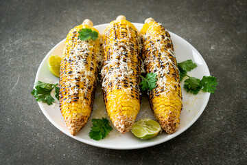 barbecue and grilled corn with cheese and lime