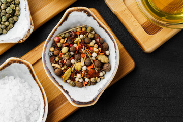 Oil, herbs and spices on wooden background