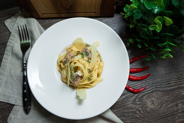 Creamy tagliatelle pasta (fettuccini) with mushrooms and parmesan cheese