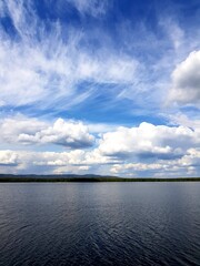 White clouds over a dark lake