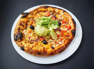 pizza on the black background, top view