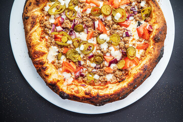 pizza on the black background, top view