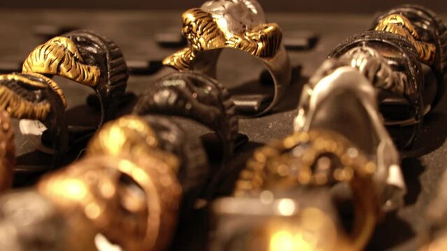 Close-up of terribly gold and silver skull rings.Skull rings that bikers or goths often wear.