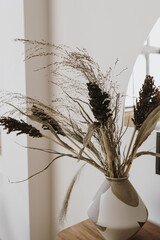 Dried pampas grass bouquet in clay pot. Modern aesthetic minimalist home living room interior design decoration details. Elegant luxury apartment decor