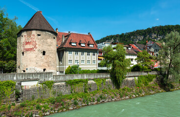 Fototapeta na wymiar Feldkirch, Austria - May 20, 2022: View of the old town of Feldkirch with the water tower on the banks of the river Ill