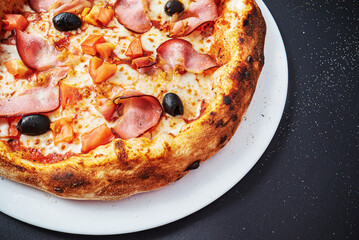 pizza on the black background, top view