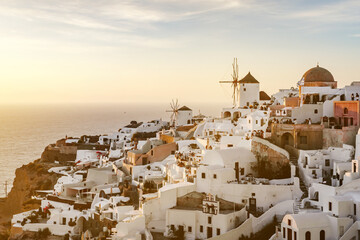 The Oia village on Santorini island in Greece during beautiful sunset with colorful clouds.