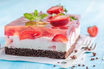 Fresh strawberry jelly cake with fruity layer surrounded by jelly.