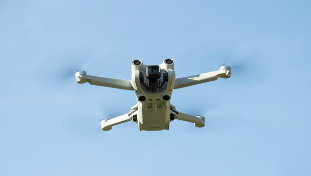 IASI, ROMANIA - MAY 21 2022: DJI Mini 3 Pro drone flying with blue sky background