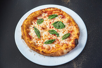 pizza on the black background, top view