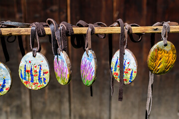 Group of colourful hand painted mixed necklaces and suvenirs displayed for sale at a traditional...