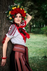 Obraz premium Ukrainian woman in national costume walks in the city park