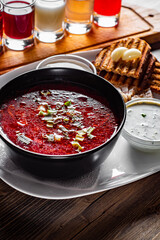 Beetroot soup Traditional Ukrainian or Russian borscht with sour cream in a bowl on wooden table