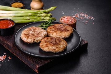 Flat lay composition with grilled meat cutlets for burger on black concrete table