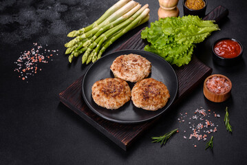 Flat lay composition with grilled meat cutlets for burger on black concrete table
