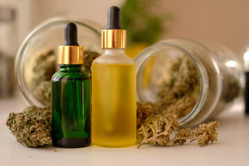CBD oil on background with dry cannabis buds. Marihuana extract.