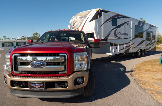 Florida, USA. 2022. A big red Ford towing a recreational vehicle.