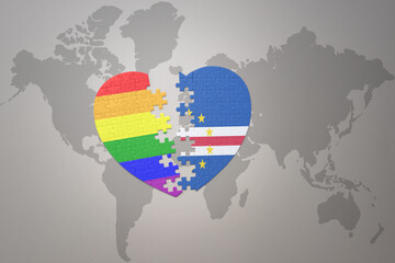 puzzle heart with the rainbow gay flag and cape verde on a world map background. Concept.