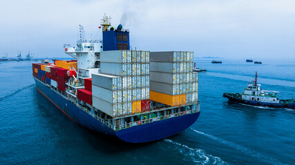 Fototapeta premium Stern of large cargo ship import export container box on the ocean sea on blue sky back ground concept transportation logistic and service to customer and supply change
