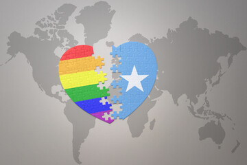 puzzle heart with the rainbow gay flag and somalia on a world map background. Concept.
