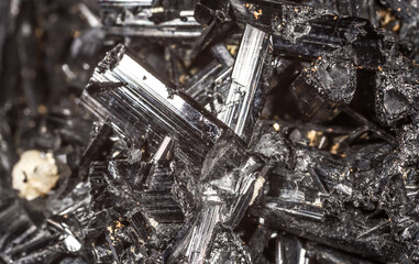 Tourmaline black crystals. Gems. Mineral crystals in the natural environment. Texture of precious and semiprecious stones. Seamless background with copy space colored shiny surface of precious stones.