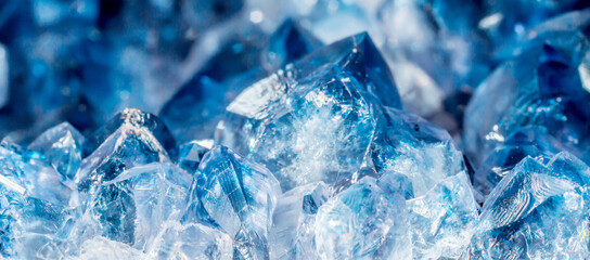 Blue Crystal Mineral Stone. Gems. Mineral crystals in the natural environment. Texture of precious and semiprecious stones. Seamless background with copy space colored shiny surface of precious stones
