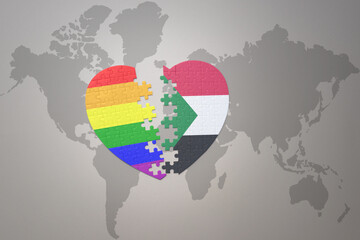 puzzle heart with the rainbow gay flag and sudan on a world map background. Concept.