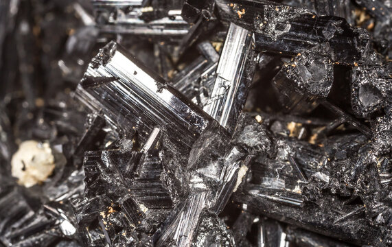 Tourmaline black crystals. Gems. Mineral crystals in the natural environment. Texture of precious and semiprecious stones. Seamless background with copy space colored shiny surface of precious stones.