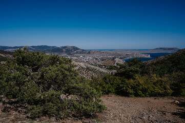 View of ancient city of Sudak and Genoese fortress on Black Sea coast in Crimea on sunny summer day
