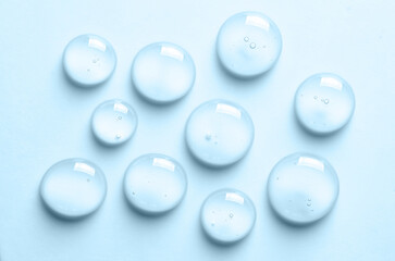 Blue drops of gel close-up. Cosmetic product for moisturizing the skin of the face or body. - obrazy, fototapety, plakaty