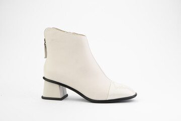 Women's autumn ankle white leather boots with zip and average heels, isolated white background. Right side view. Fashion shoes.