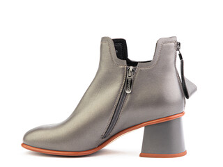 Women's autumn ankle grey leather boots with zip and average heels, isolated white background. Left side view. Fashion shoes.