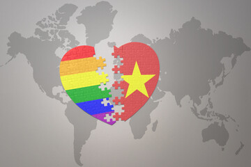 puzzle heart with the rainbow gay flag and vietnam on a world map background. Concept.