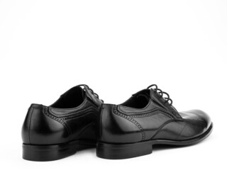 A pair of classic leather elegant men's shoes isolated white background. Groom's stylish black shoes. Isolated object close up on white background.