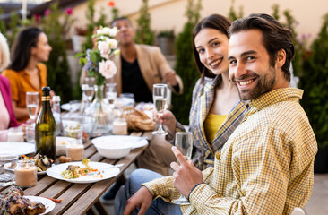 Family and friends celebrating at dinner on a rooftop terrace