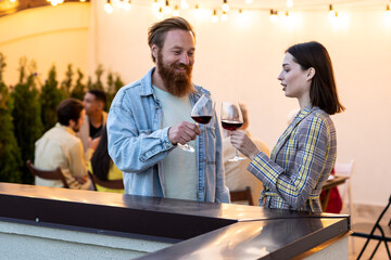 Family and friends celebrating at dinner on a rooftop terrace