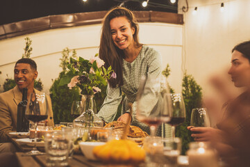 Family and friends celebrating at dinner on a rooftop terrace