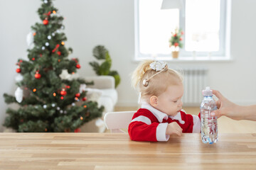 Child with cochlear implant hearing aid in christmas living room copy space - deafness treatment and medical innovative technologies