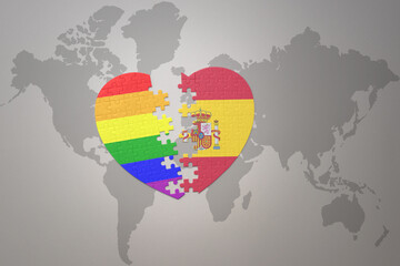 puzzle heart with the rainbow gay flag and spain on a world map background. Concept.