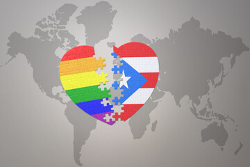 puzzle heart with the rainbow gay flag and puerto rico on a world map background. Concept.