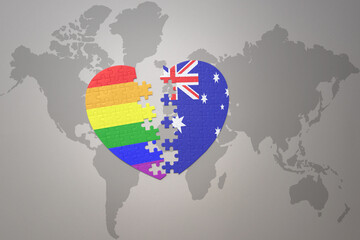 puzzle heart with the rainbow gay flag and australia on a world map background. Concept.