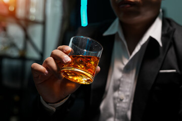 Closeup businessmen holding a glass of whiskey