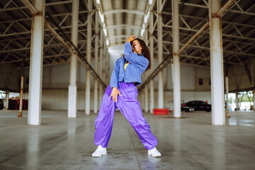 Young  woman - dancer dancing  in the underpass. Sport, dancing and urban culture concept.