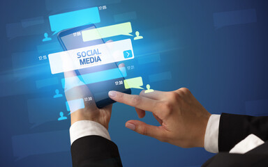 Hand using smartphone with social media concept