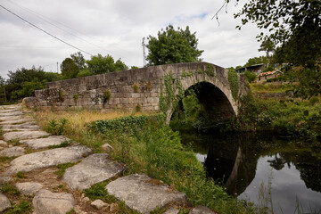 Fototapeta na wymiar Mondim de Basto (Portugal), May 16, 2022. Cabril River Bridge. Medieval town, it was crossed by the armies of Rome and Napoleon. It is part of the Camino de Santiago.