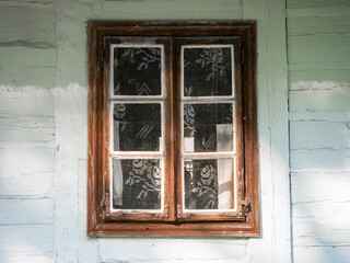 Obraz premium A window in a white wooden hut, Traditional wooden hut, Wooden traditional window, Poland